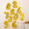 A collection of gold foil number balloons spelling out 8247306