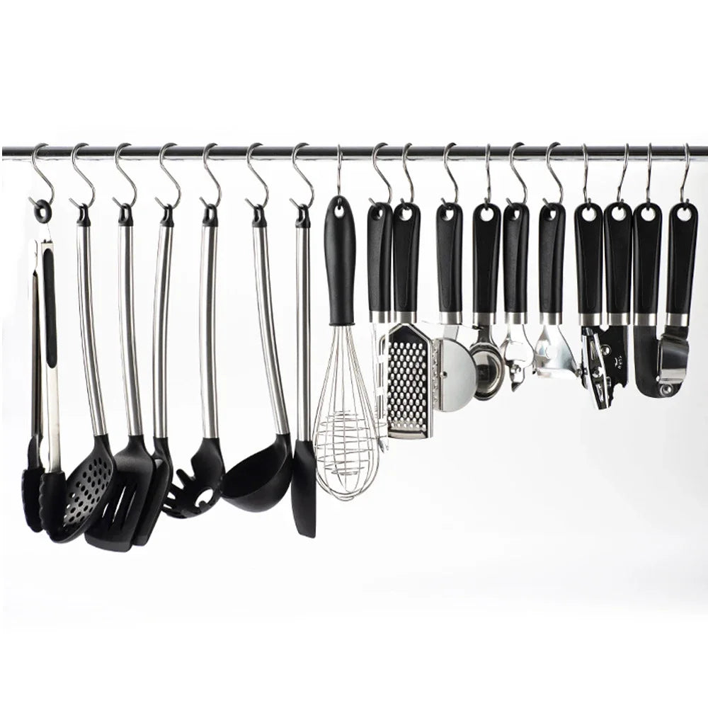 A set of ten S-shape stainless steel hanging kitchen tools, including spatulas and whisks, are displayed on a rack.