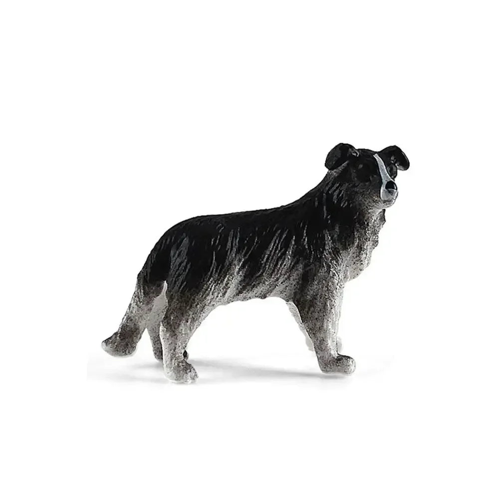 A realistic figurine of a black and gray dog.