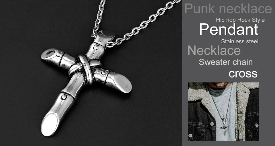 Silver stainless steel cross pendant necklace with a chain displayed against a dark background.