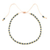 Handmade boho glass bead bracelet with adjustable cord featuring black and gold beads.