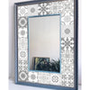 A rectangular mirror framed in dark blue, featuring a decorative patterned border and reflecting the room.