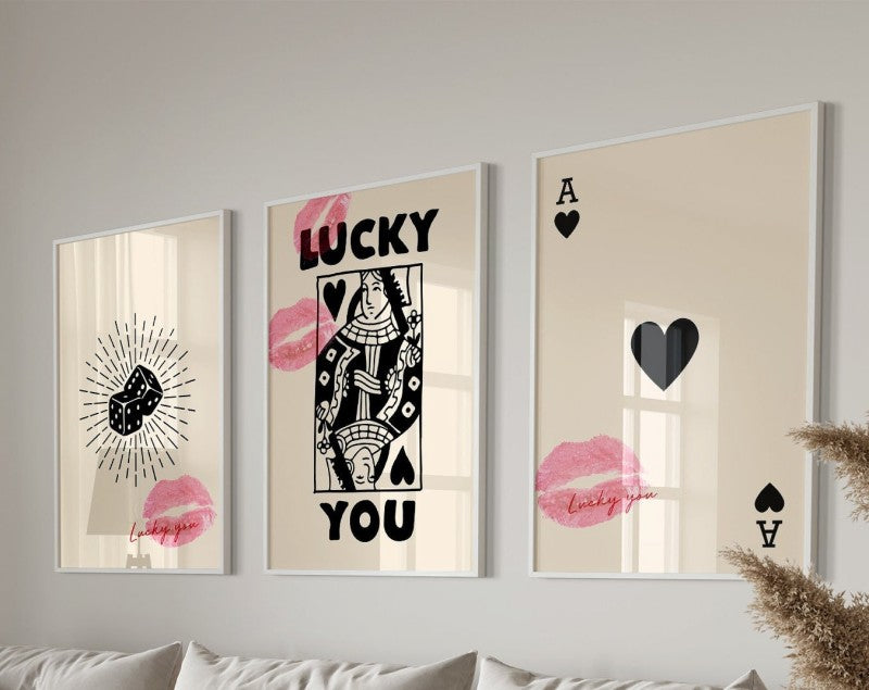 Three framed art prints featuring pink lips and black text on a light background