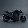 A black 3D printed racing motorcycle rider figurine displayed on a dark surface.