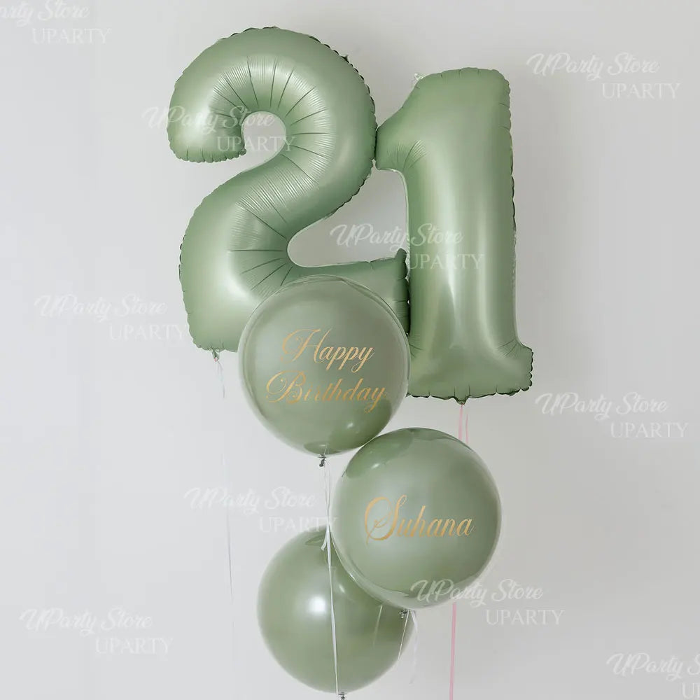 A cluster of large foil number balloons shaped like 1 and a curved 9 in a muted sage green color.