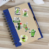 A notebook decorated with cartoon pickle stickers featuring text like I love pickles and Queen of the Pickles.