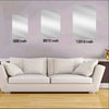 A row of three rectangular silver aluminum wall decor signs in different sizes mounted on a light purple wall above a white s