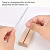 A hand is tearing a transparent film off an inspirational acrylic desktop sign for use.
