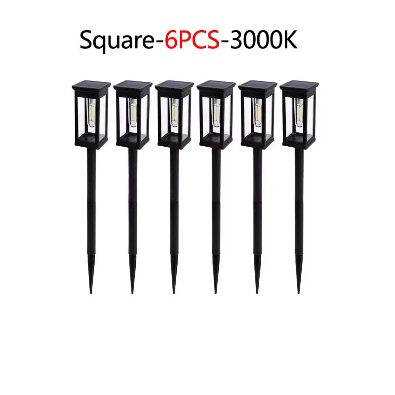 Six black square solar pathway lights with illuminated bulbs.