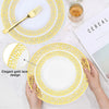 A set of elegant gold rim plastic dinner and dessert plates with a decorative lace design on a white background.
