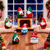 A set of festive resin Christmas dwarf figurines, including red and green figures, displayed in a cozy living room setting.