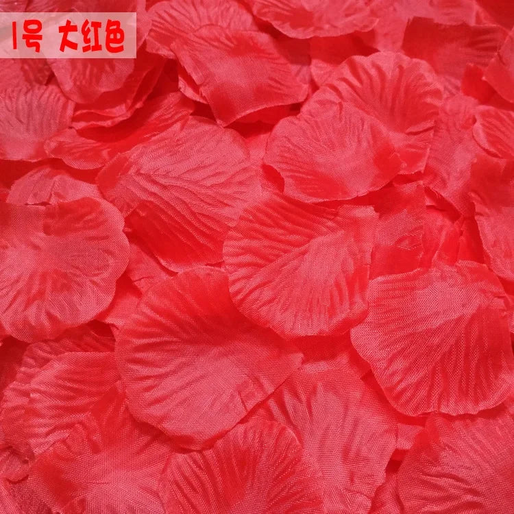 A close-up of vibrant red silk rose petals used for weddings and events.