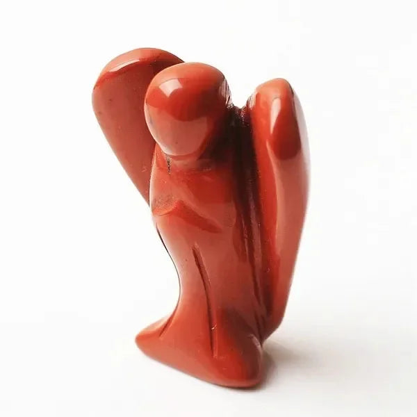 Hand-carved reddish-orange crystal figurine of an angel.