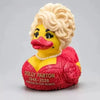 A collectible figurine of Dolly Parton as a yellow duck with blonde hair and a red outfit.
