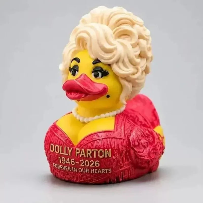 A collectible figurine of Dolly Parton as a yellow duck with blonde hair and a red outfit.