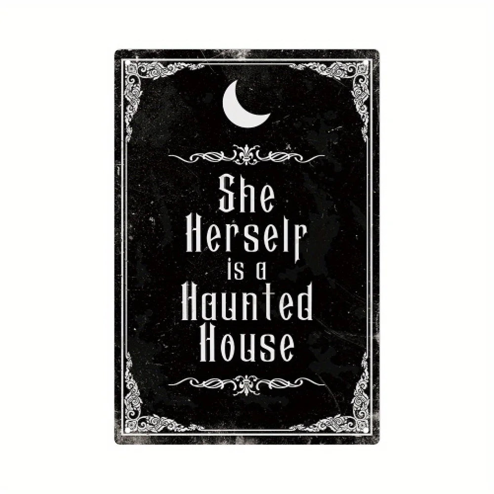 A black metal tin sign featuring a crescent moon and the text She Herself is a Haunted House in an ornate gothic style.