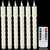 A set of six white fluted taper candles with electric LED wicks and on/off switches.