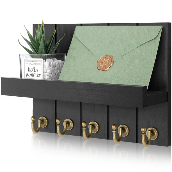 Rustic wooden wall-mounted organizer featuring a green envelope and five brass hooks.