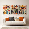 A set of three framed floral canvas prints featuring colorful Scandinavian folk art designs on a light wall.