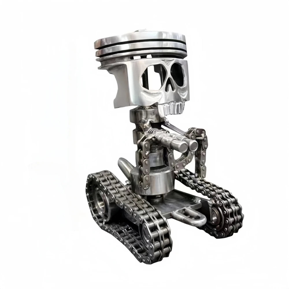 A silver mechanical piston skull sculpture with a metal track base.