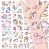 A collection of glitter unicorn temporary tattoos for kids on white sheets.