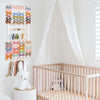 A display of colorful fabric headbands and a white bunny figurine mounted on a wall.