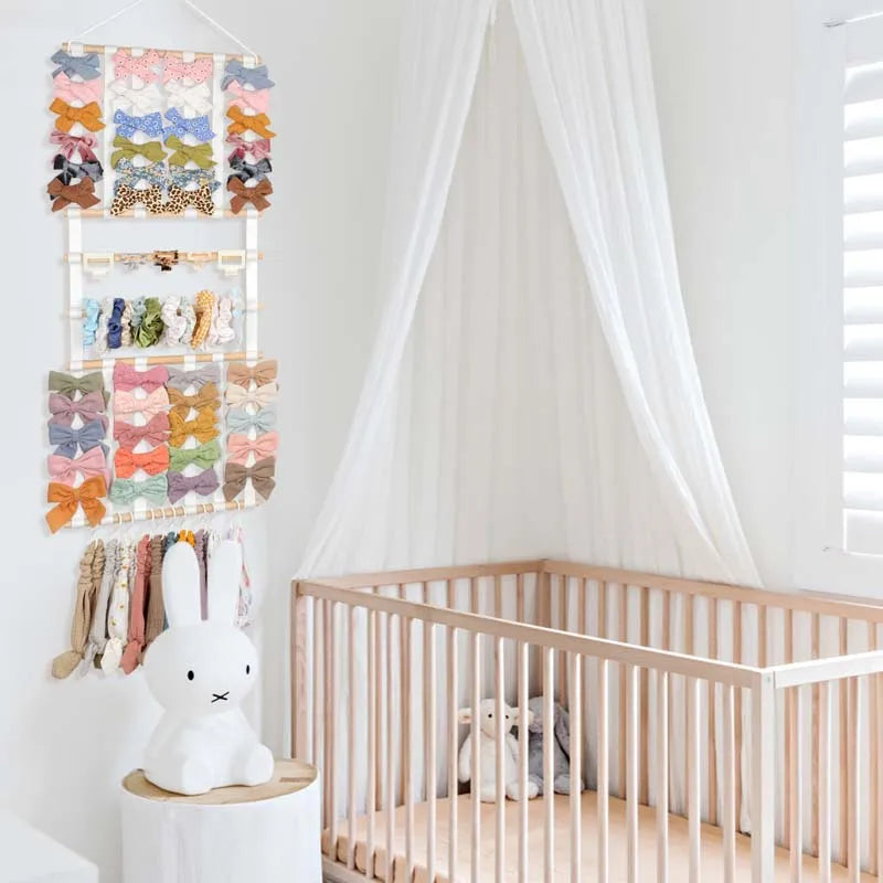 A display of colorful fabric headbands and a white bunny figurine mounted on a wall.