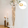 Boho macrame dream catcher wall decor featuring a star shape and hanging macrame strands on a white wall.
