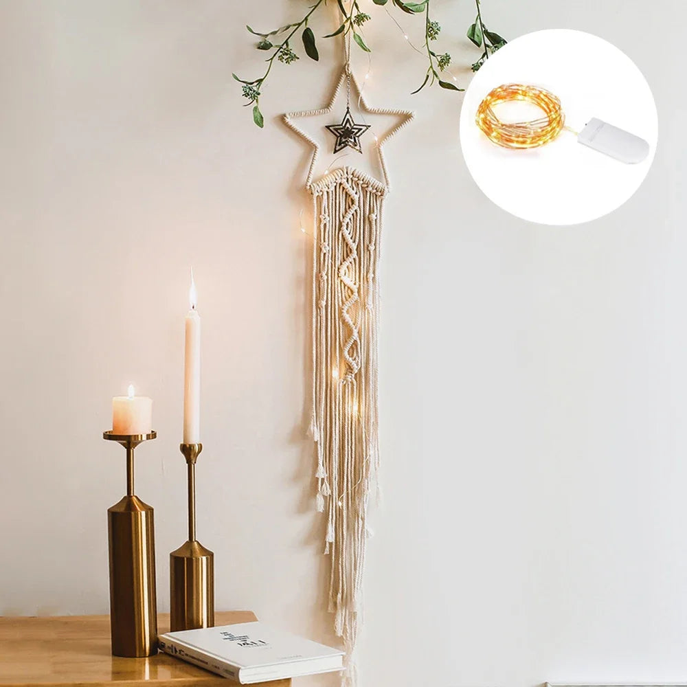 Boho macrame dream catcher wall decor featuring a star shape and hanging macrame strands on a white wall.