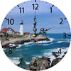 A round clock face showing a coastal scene with a lighthouse and waves, featuring a dark wooden clock hand.