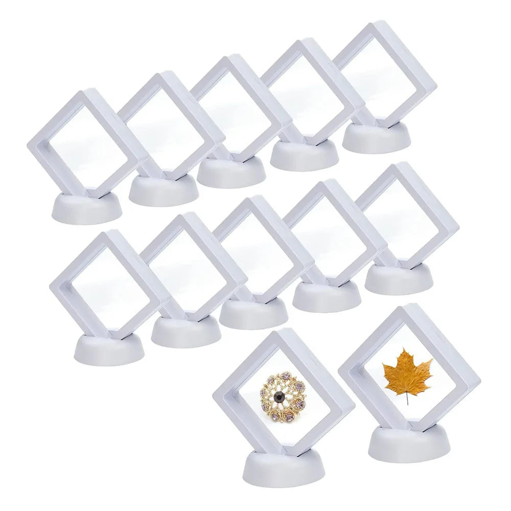A set of ten white floating shadow box jewelry display frames with small white bases.