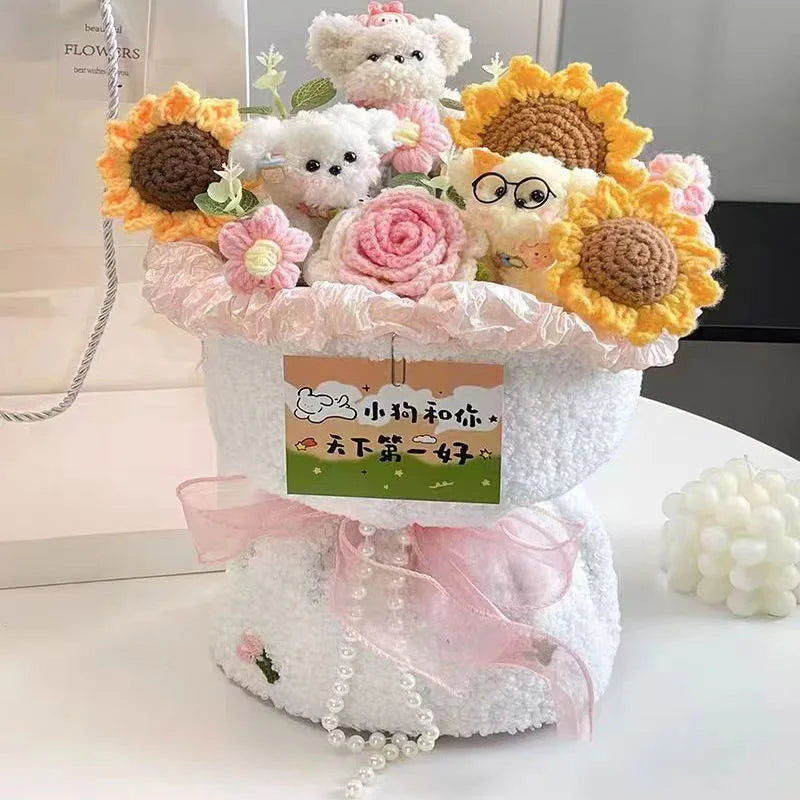 A handmade crochet flower bouquet featuring various pastel and yellow flowers and small animal figures displayed in a white f