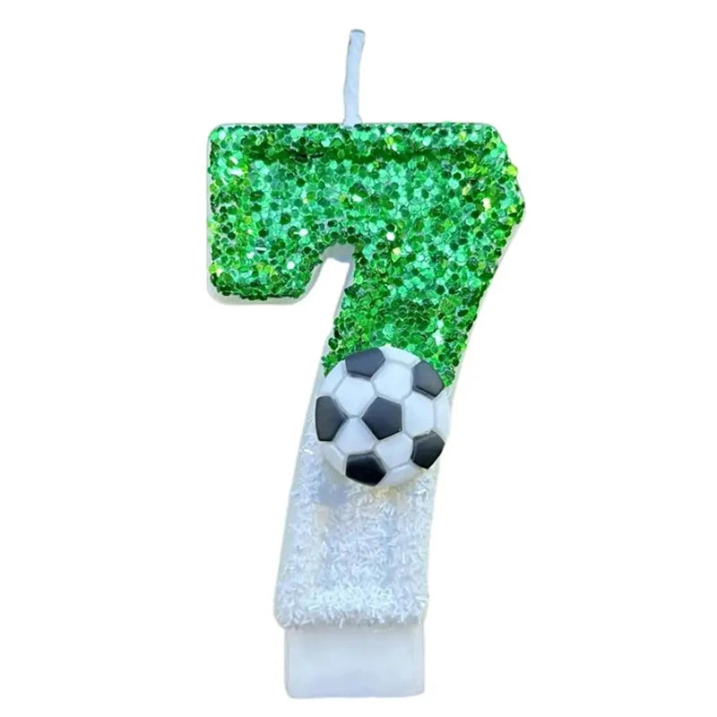 A birthday candle shaped like the number 7 covered in green glitter and topped with a soccer ball decoration.
