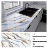 A black sink is installed into a white marble countertop featuring gold and blue veining, with an inset showing the marble pa