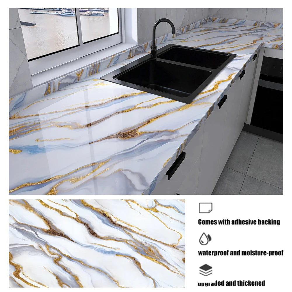 A black sink is installed into a white marble countertop featuring gold and blue veining, with an inset showing the marble pa