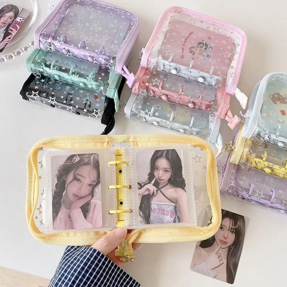 A collection of glitter star card binders in purple and pink, showing various collectible cards.