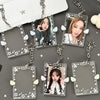 Clear acrylic photocard holders with attached keychain charms featuring various star and wing designs.