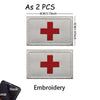Two gray embroidered medical cross patches with silver edges and a black hook loop.