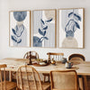 Three abstract geometric wall art prints featuring blue and beige tones with vertical lines and organic shapes.