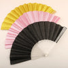 A folding fan with a rainbow gradient of glitter colors, including yellow, pink, and black.