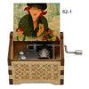 A hand-cranked wooden music box featuring an illustration of characters from Once Upon a December.