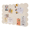 A scalloped felt bulletin board with a cloud-shaped design featuring various small cards and notes.