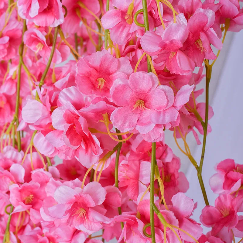 Pink sakura flower garland featuring clusters of delicate pink blossoms and green stems