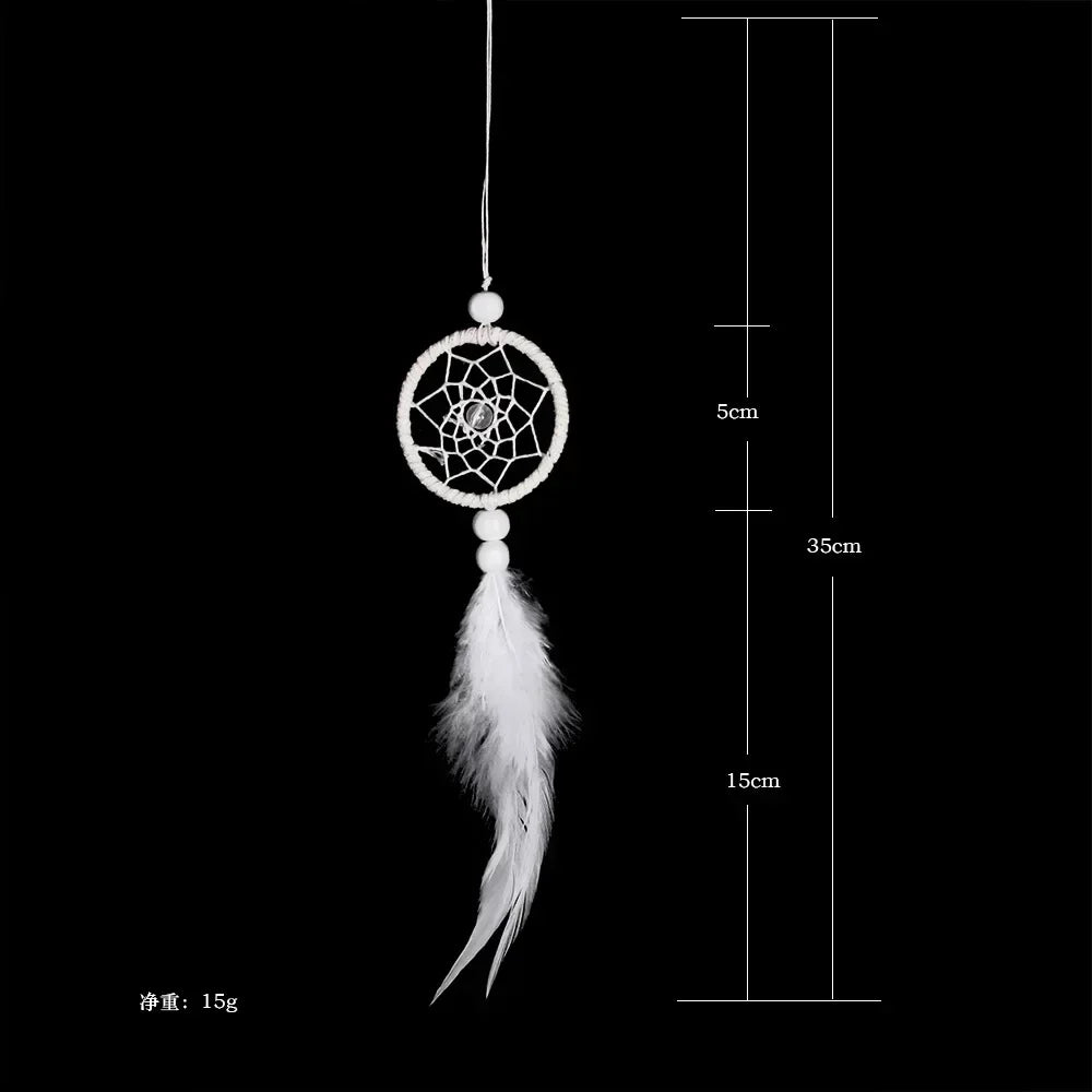 A feather pendant charm with a circular mirror design suspended by a thin cord.