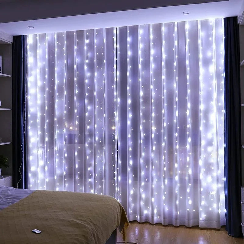 Sheer white curtain illuminated by vertical strings of twinkling LED lights in a bedroom setting