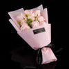 A pink paper bouquet of handcrafted soap roses in a light pink wrapper.