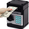 A hand is inserting a stack of US dollar bills into a black combination lock piggy bank.