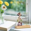 A clear acrylic desktop statue depicting a praying couple with flowers and text about faith.