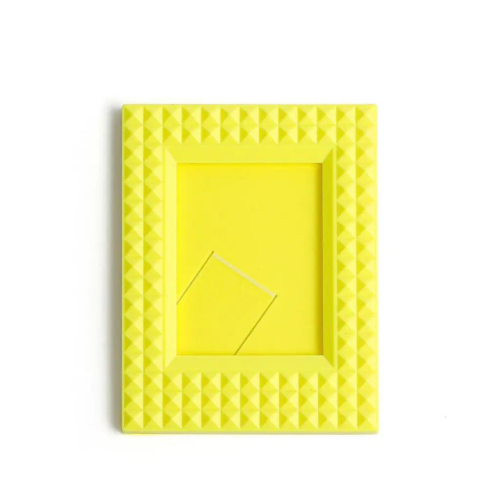 A yellow mini film frame designed to hold Fuji Instax instant photos.