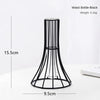 A black wrought iron waist bottle vase with a narrow neck and flared base, shown on a white surface.